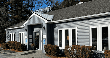 A photo from the front of a small company building, one who has recently renovated its roof