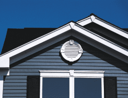 A beautifully-crafted gable-end vent installed at the crest of a home