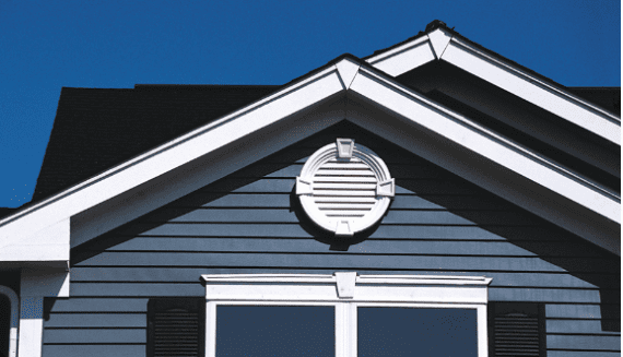 A beautifully-crafted gable-end vent installed at the crest of a home