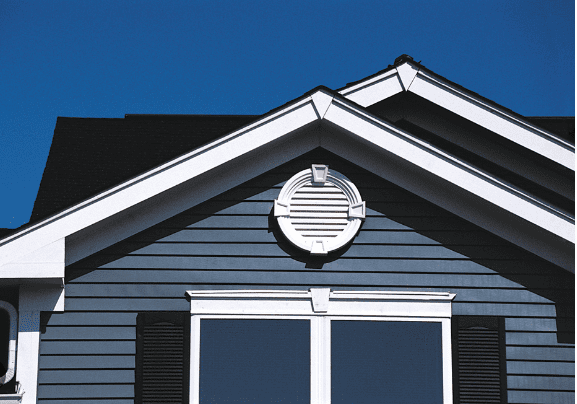 A beautifully-crafted gable-end vent installed at the crest of a home