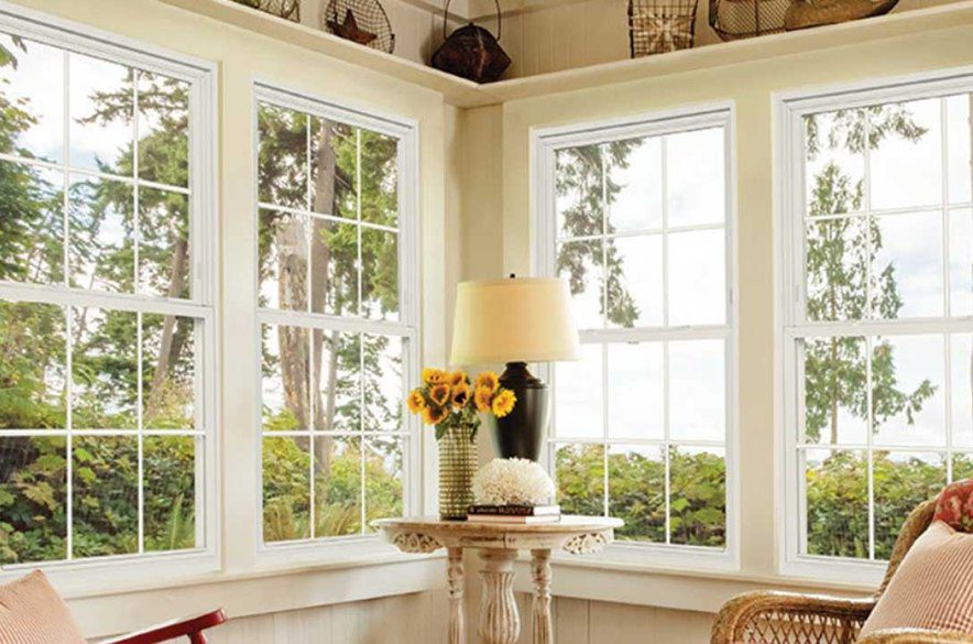 Four vinyl windows installed in a living room